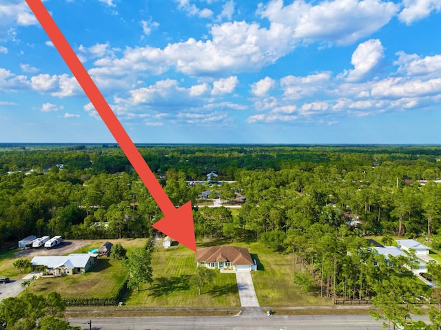 drone / aerial view featuring a wooded view