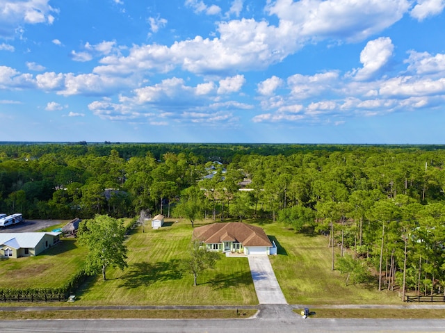 bird's eye view featuring a wooded view