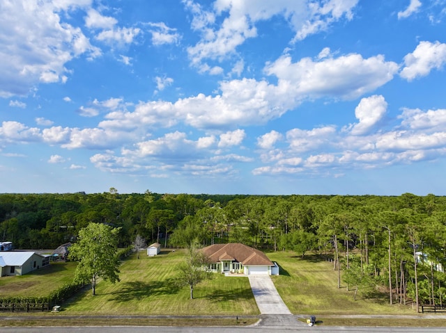 birds eye view of property with a wooded view