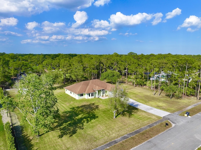 drone / aerial view featuring a view of trees