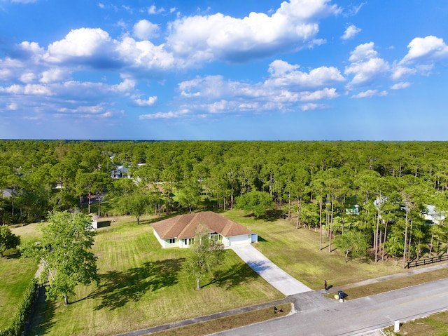 drone / aerial view featuring a view of trees