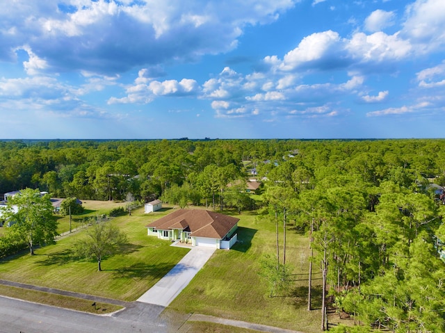 birds eye view of property with a wooded view