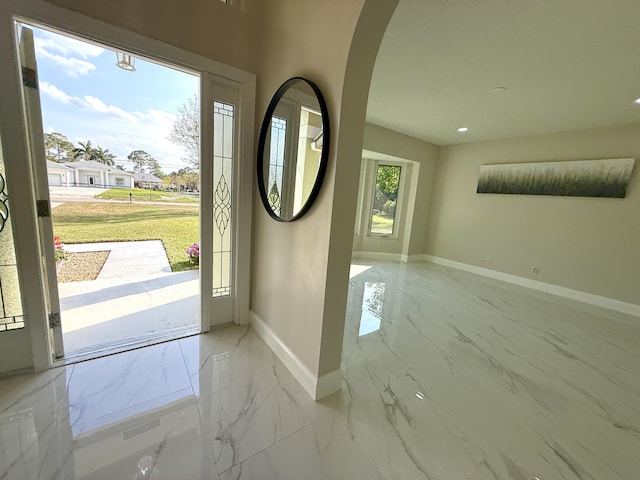 entryway with recessed lighting, baseboards, and marble finish floor