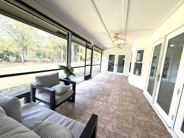 sunroom / solarium with beamed ceiling and a ceiling fan