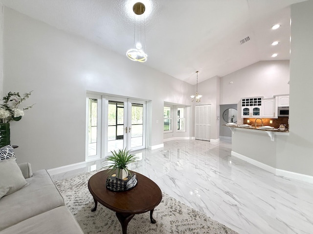 living room with visible vents, baseboards, recessed lighting, marble finish floor, and high vaulted ceiling