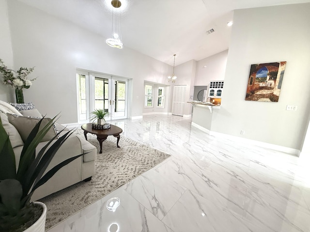 living area with visible vents, baseboards, recessed lighting, marble finish floor, and high vaulted ceiling