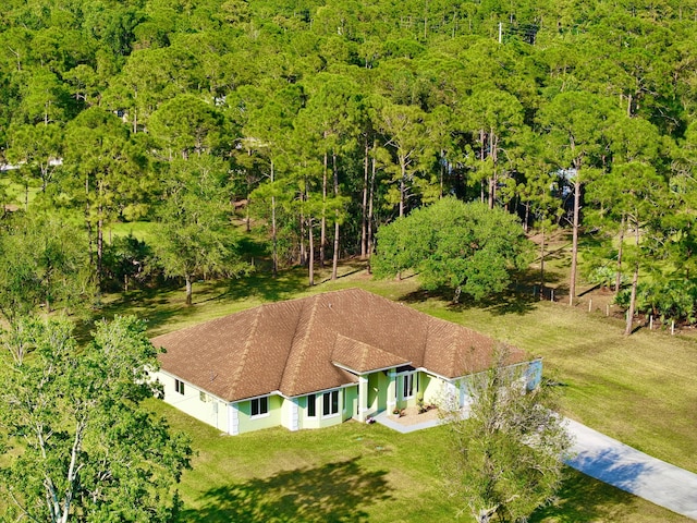 birds eye view of property featuring a view of trees