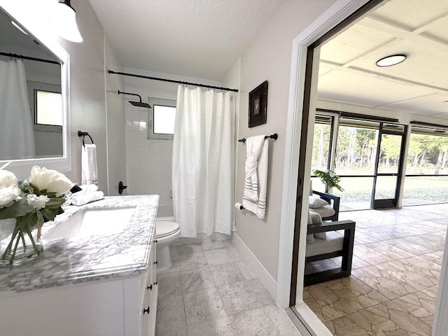 bathroom featuring vanity, a healthy amount of sunlight, marble finish floor, and baseboards