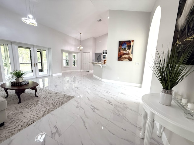 living area with baseboards, visible vents, high vaulted ceiling, french doors, and marble finish floor