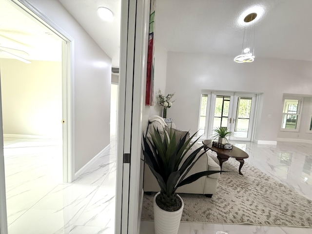 interior space with baseboards and marble finish floor