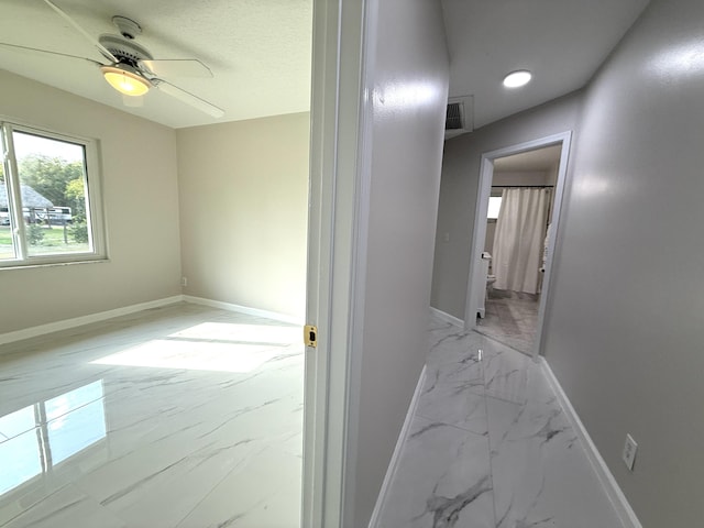 corridor featuring recessed lighting, visible vents, marble finish floor, and baseboards