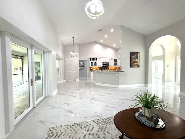 living room with visible vents, baseboards, arched walkways, marble finish floor, and a chandelier