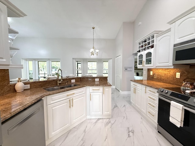 kitchen with backsplash, white cabinets, marble finish floor, stainless steel appliances, and a sink