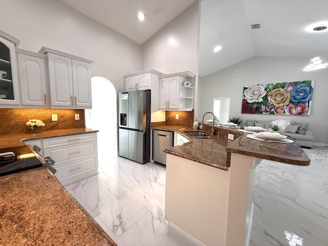 kitchen with marble finish floor, a sink, appliances with stainless steel finishes, a peninsula, and white cabinets