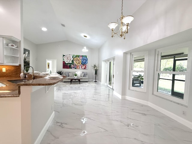 kitchen featuring open floor plan, marble finish floor, open shelves, and a sink