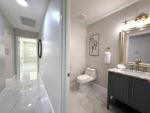 bathroom featuring visible vents, marble finish floor, and toilet