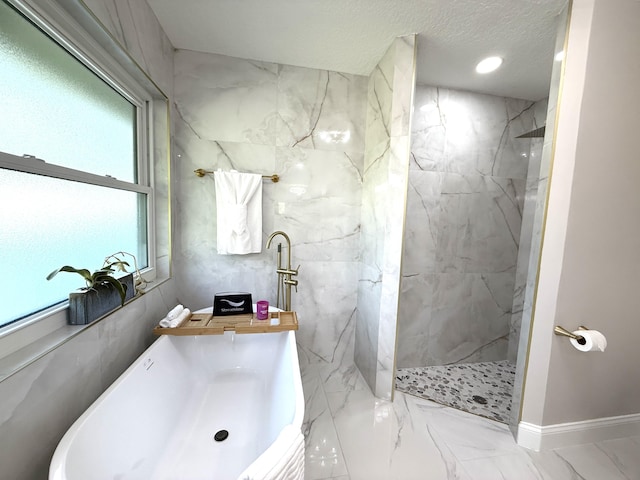 full bathroom with a marble finish shower, marble finish floor, a textured ceiling, and baseboards