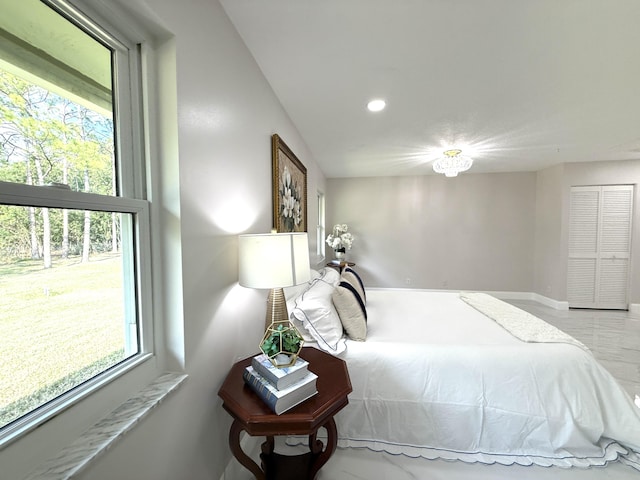 bedroom featuring recessed lighting, marble finish floor, and baseboards