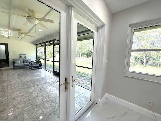 entryway with marble finish floor, french doors, a ceiling fan, and baseboards