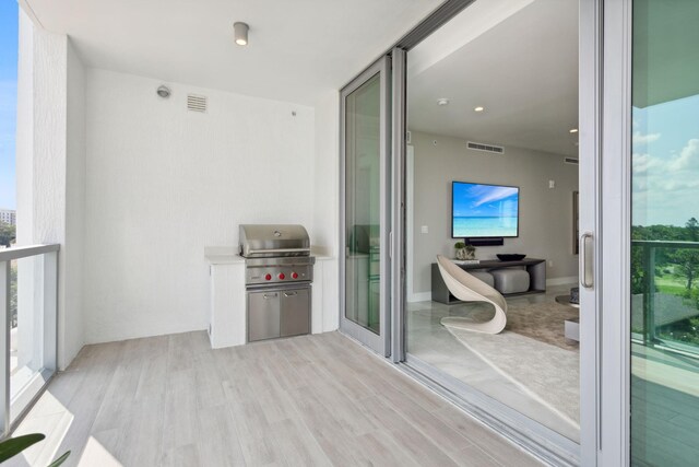 living room with a healthy amount of sunlight, sink, and light tile floors