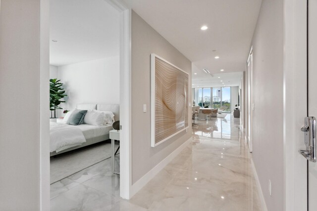 tiled bedroom with access to outside, floor to ceiling windows, and multiple windows