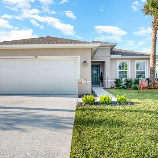 view of front of property with a front lawn and a garage