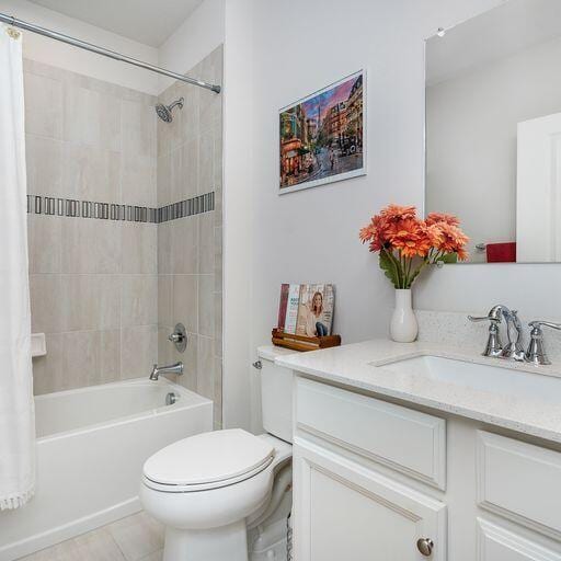 full bathroom featuring toilet, tile flooring, shower / bathtub combination with curtain, and vanity