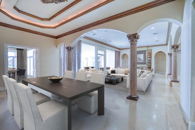 dining area featuring ornamental molding and ornate columns