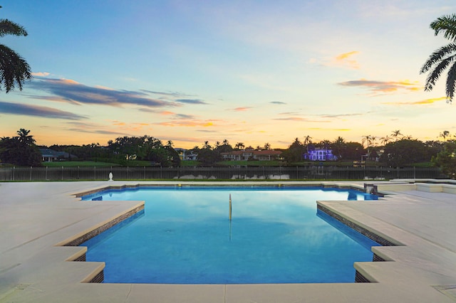 view of pool at dusk