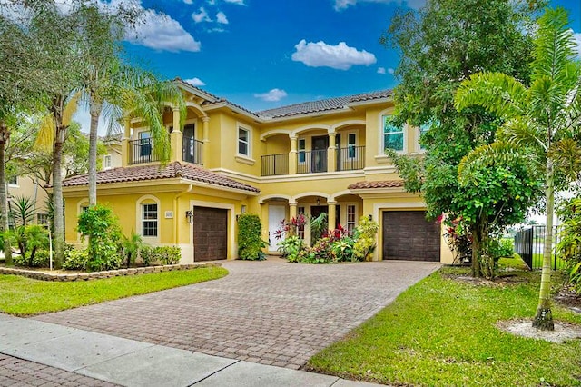 mediterranean / spanish-style house featuring a balcony and a garage