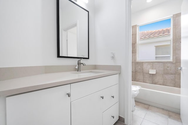 full bathroom with toilet, large vanity, tile floors, and tiled shower / bath combo