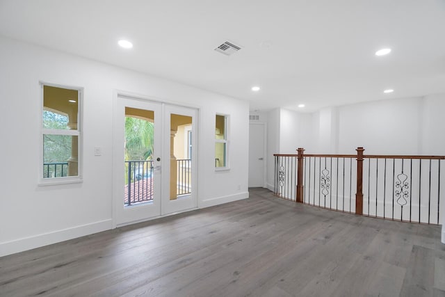 spare room featuring french doors and hardwood / wood-style flooring