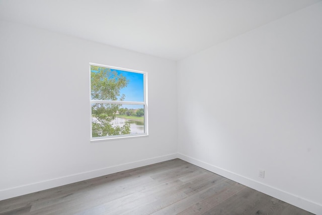 unfurnished room with dark hardwood / wood-style flooring