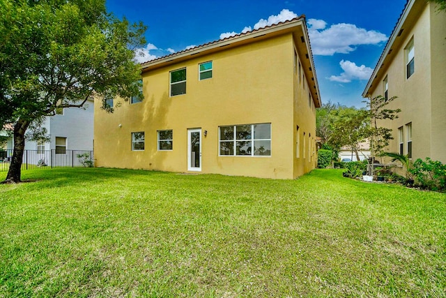 back of house with a lawn