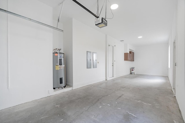 garage featuring water heater and a garage door opener