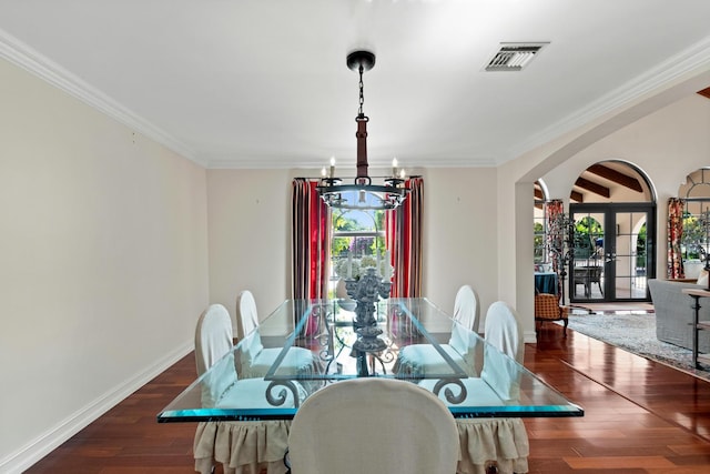 dining room with french doors, a chandelier, dark wood-type flooring, and a wealth of natural light