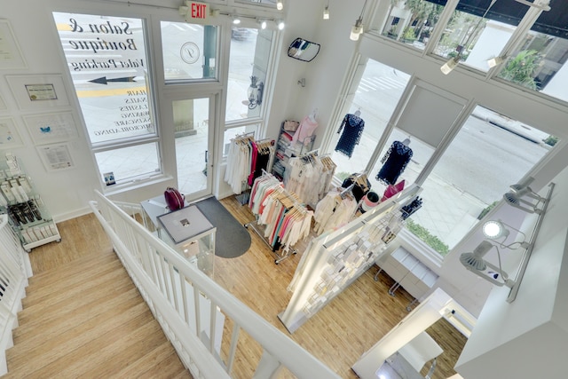 entrance foyer featuring a towering ceiling and light wood-type flooring