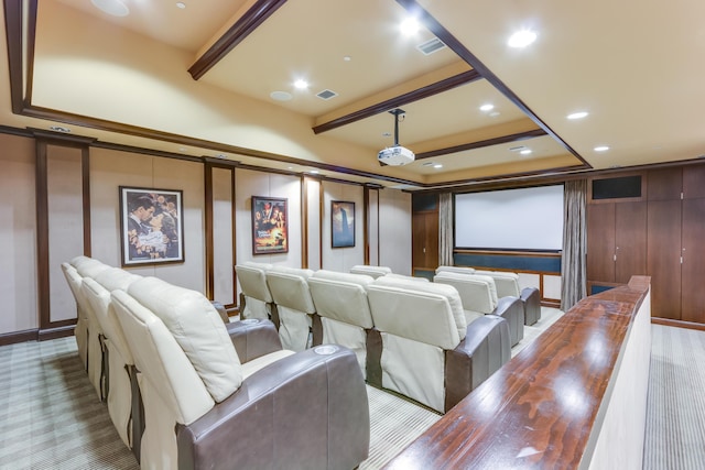 carpeted cinema room featuring beamed ceiling