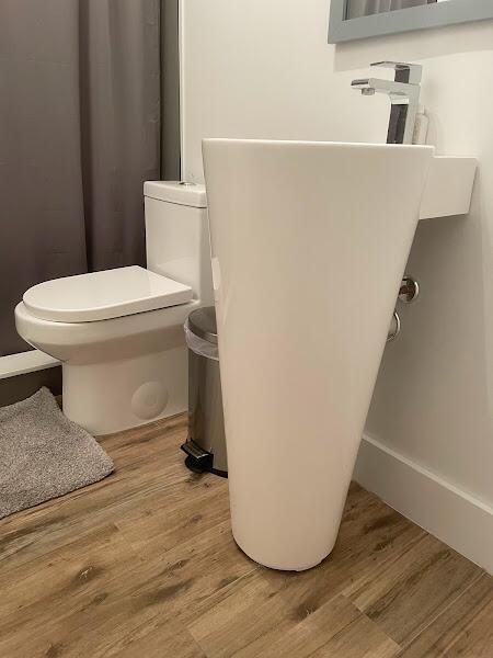 bathroom with toilet and hardwood / wood-style flooring