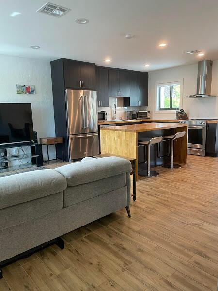 living room featuring light hardwood / wood-style floors and sink