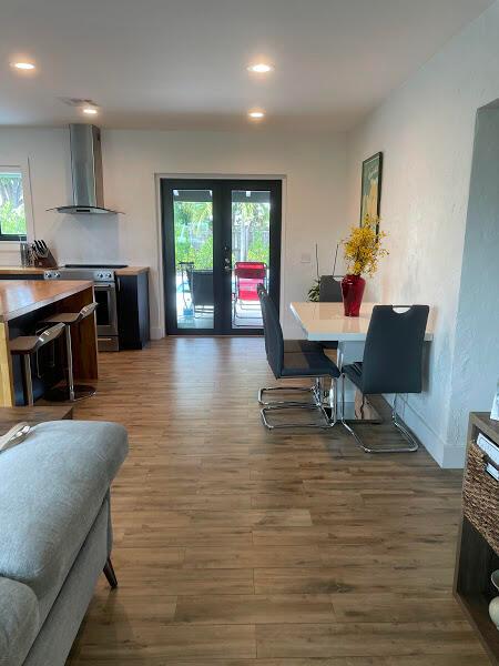 dining area featuring french doors and dark wood-type flooring