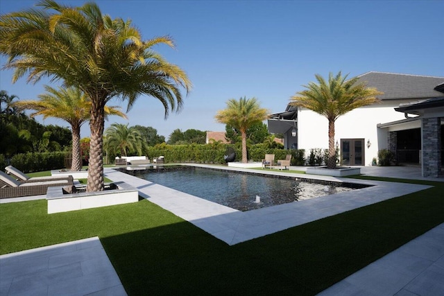 view of swimming pool with a patio area and a yard