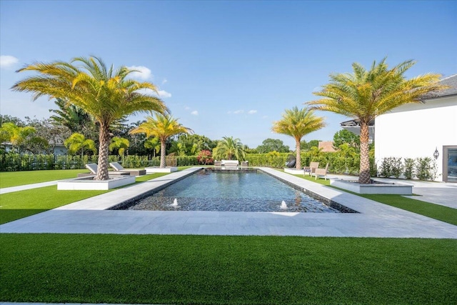 view of pool with a lawn and pool water feature