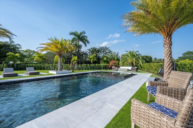 view of pool with a lawn