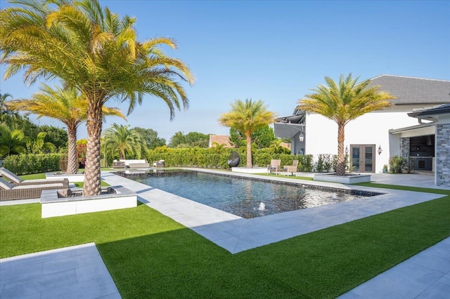 view of pool with a yard and a patio