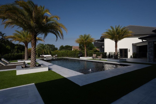 view of swimming pool with a yard and a patio area