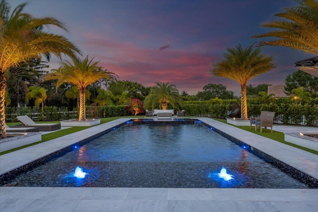 view of pool at dusk