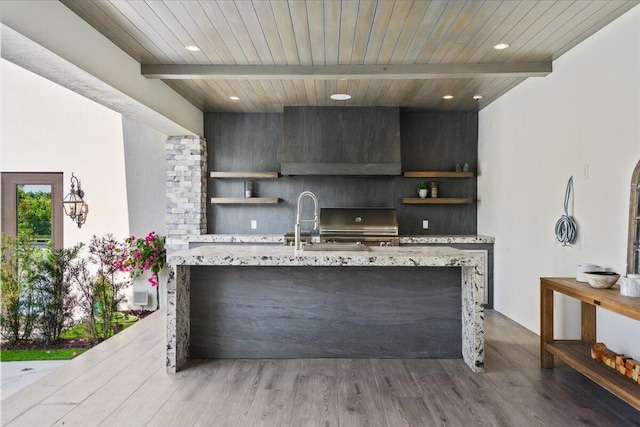 kitchen featuring wall chimney exhaust hood, wooden ceiling, hardwood / wood-style flooring, and beamed ceiling