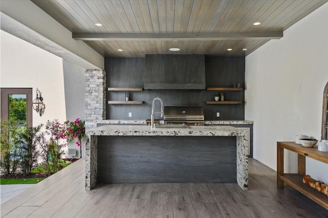 kitchen with beam ceiling, wood ceiling, wood-type flooring, and light stone countertops