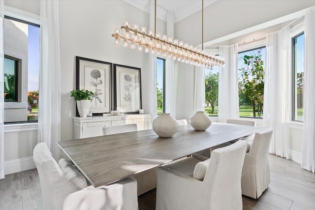 dining area with a chandelier and light wood-type flooring